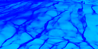 Blaue, marmorierte Wasseroberfläche mit dunklen Adern.